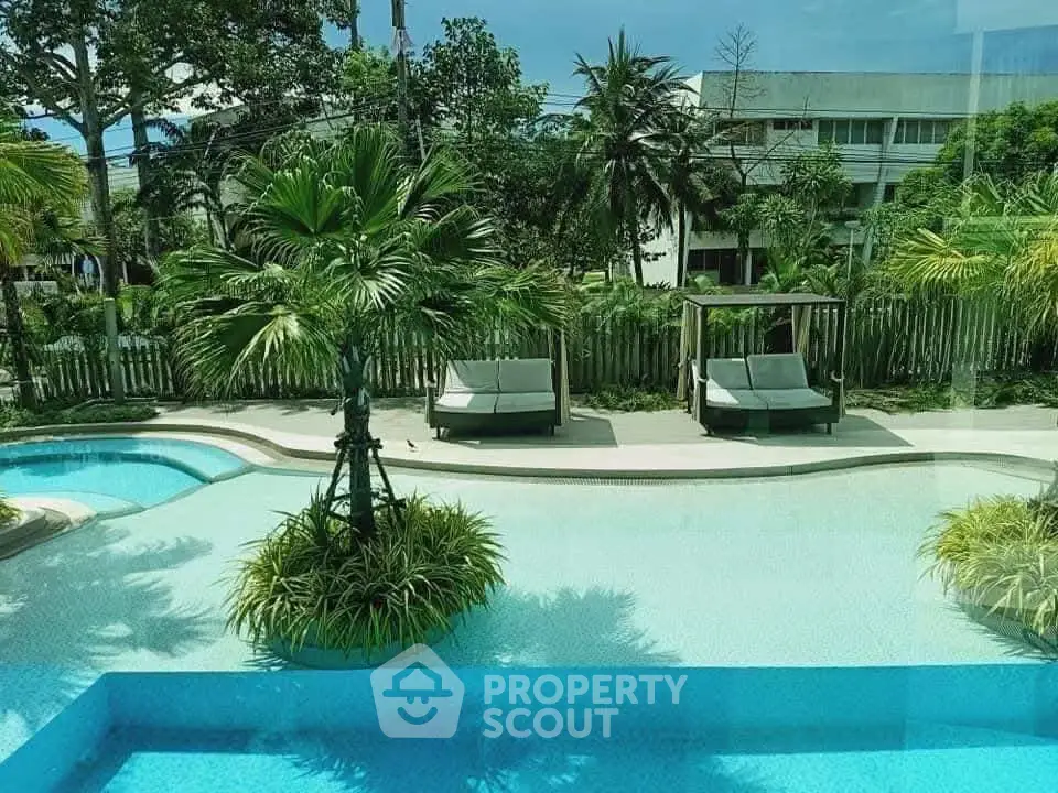 Luxurious poolside view with lush greenery and modern loungers in a serene setting.