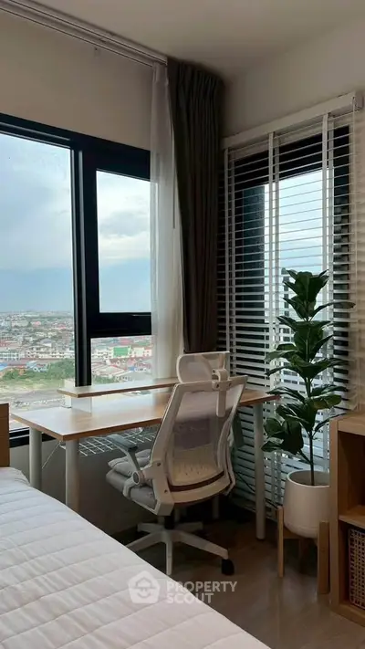 Modern bedroom with study area and panoramic city view