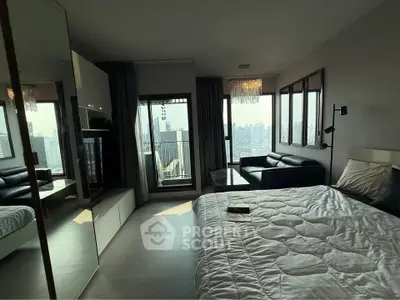 Luxurious bedroom with stunning city view and modern furnishings in high-rise apartment.