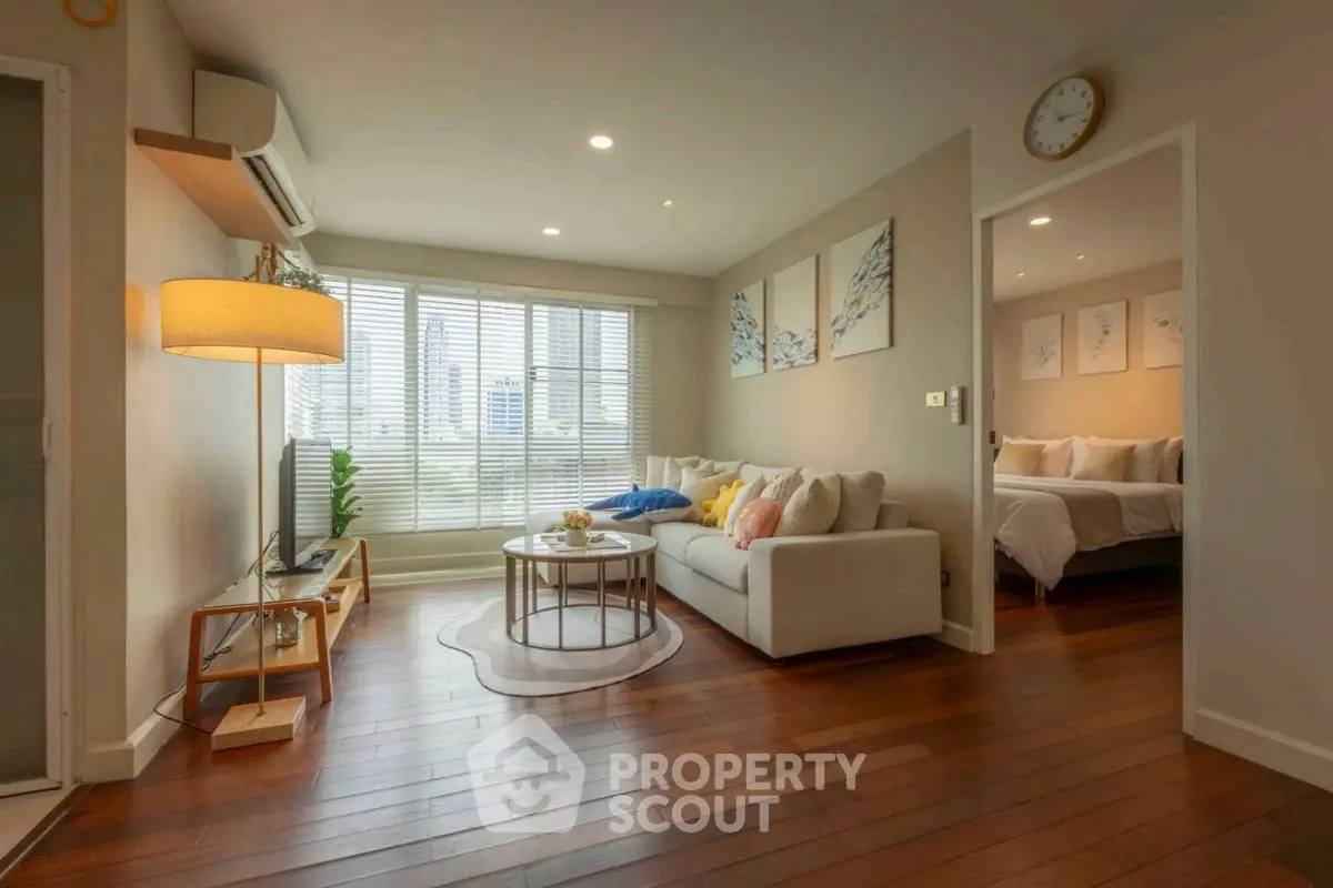 Modern living room with wooden floors and cozy sofa in a stylish apartment