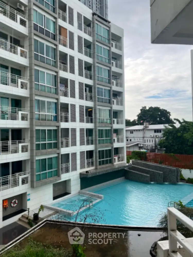 Modern apartment building with pool view, ideal for urban living