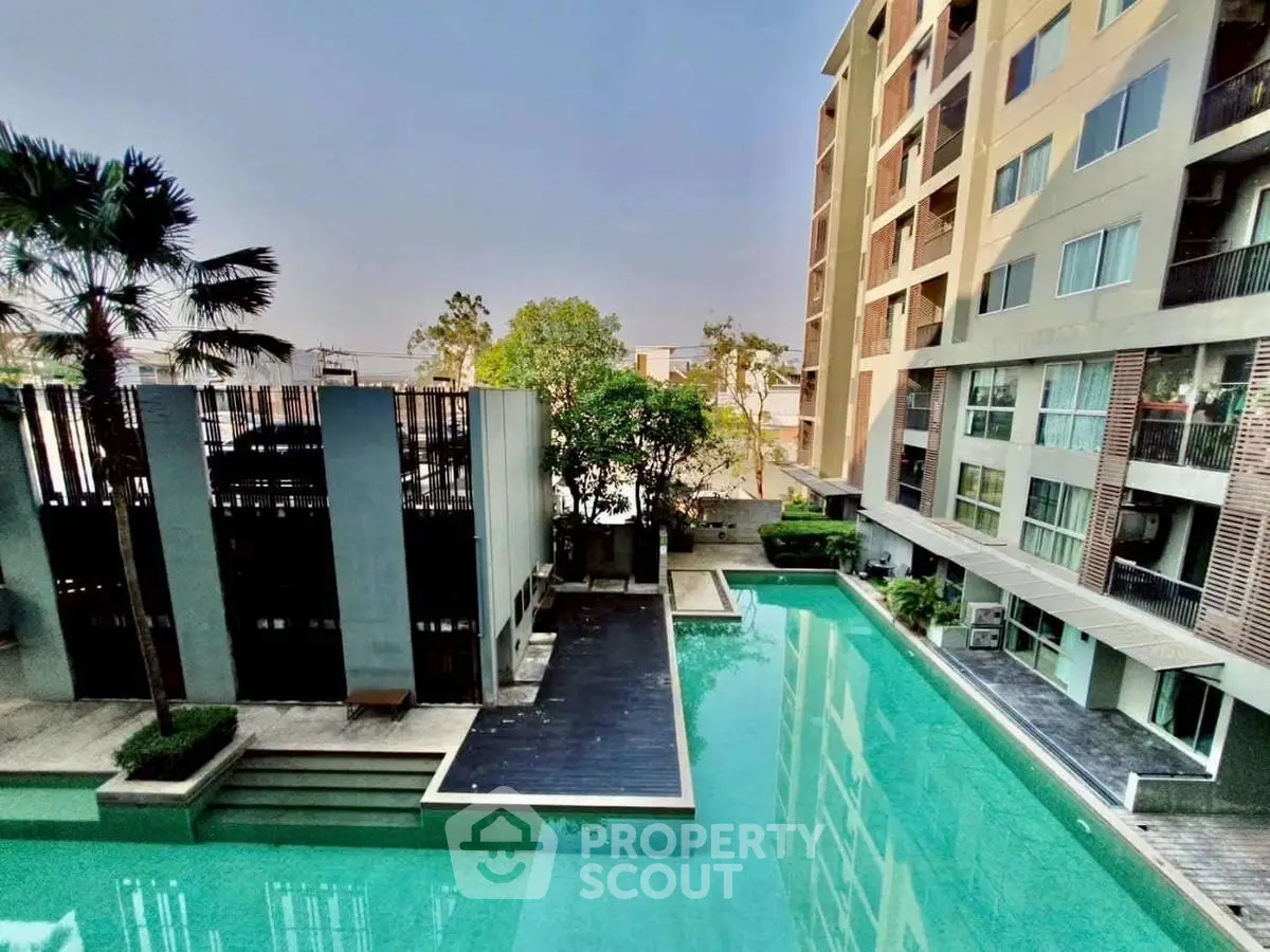 Luxurious apartment complex with stunning pool view and modern architecture.