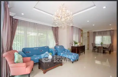Spacious living room with elegant chandelier and stylish furniture