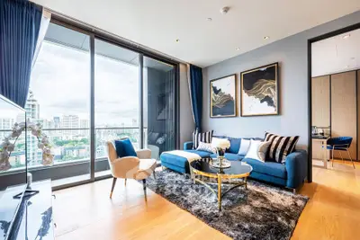 Luxurious living room with stunning city view, elegant decor, and modern furnishings in a high-rise apartment.