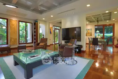 Luxurious living room with elegant decor and spacious layout, featuring large windows and stylish furniture.
