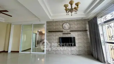 Spacious living room with modern decor and large windows for natural light.