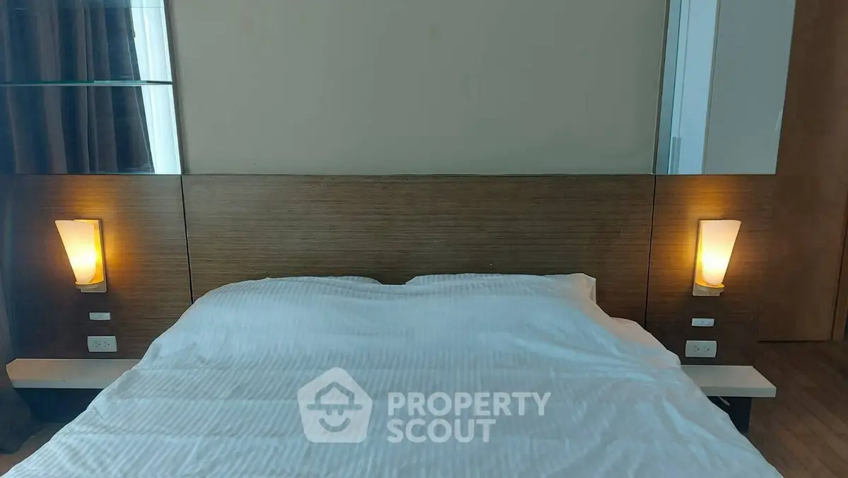 Cozy bedroom with modern lighting and wooden headboard