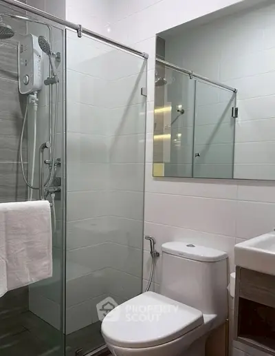 Modern bathroom with glass shower enclosure and sleek fixtures