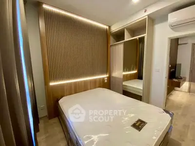 Modern bedroom with stylish wood paneling and built-in wardrobe in a cozy apartment.
