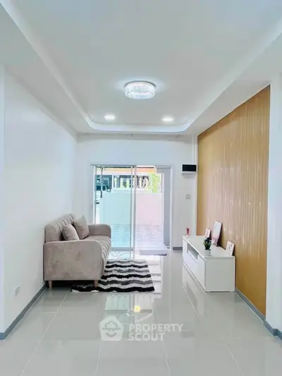 Modern living room with sleek design and access to spacious balcony