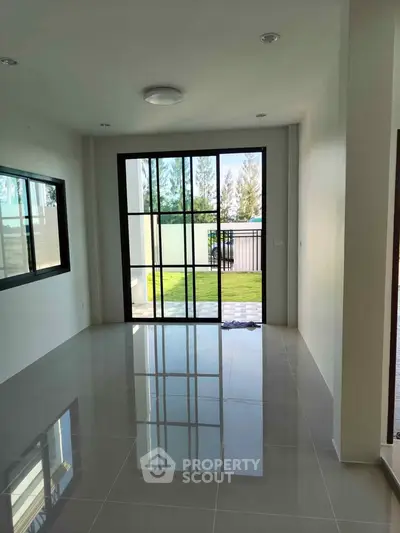 Spacious modern living room with large windows and garden view