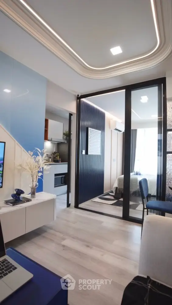 Modern open-plan living room with sleek kitchen and stylish bedroom view