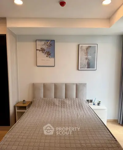 Modern bedroom with stylish decor and cozy ambiance, featuring a comfortable bed and elegant wall art.