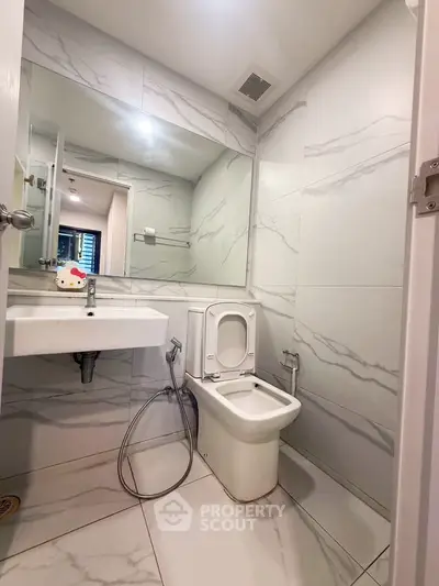 Modern bathroom with sleek marble tiles and contemporary fixtures