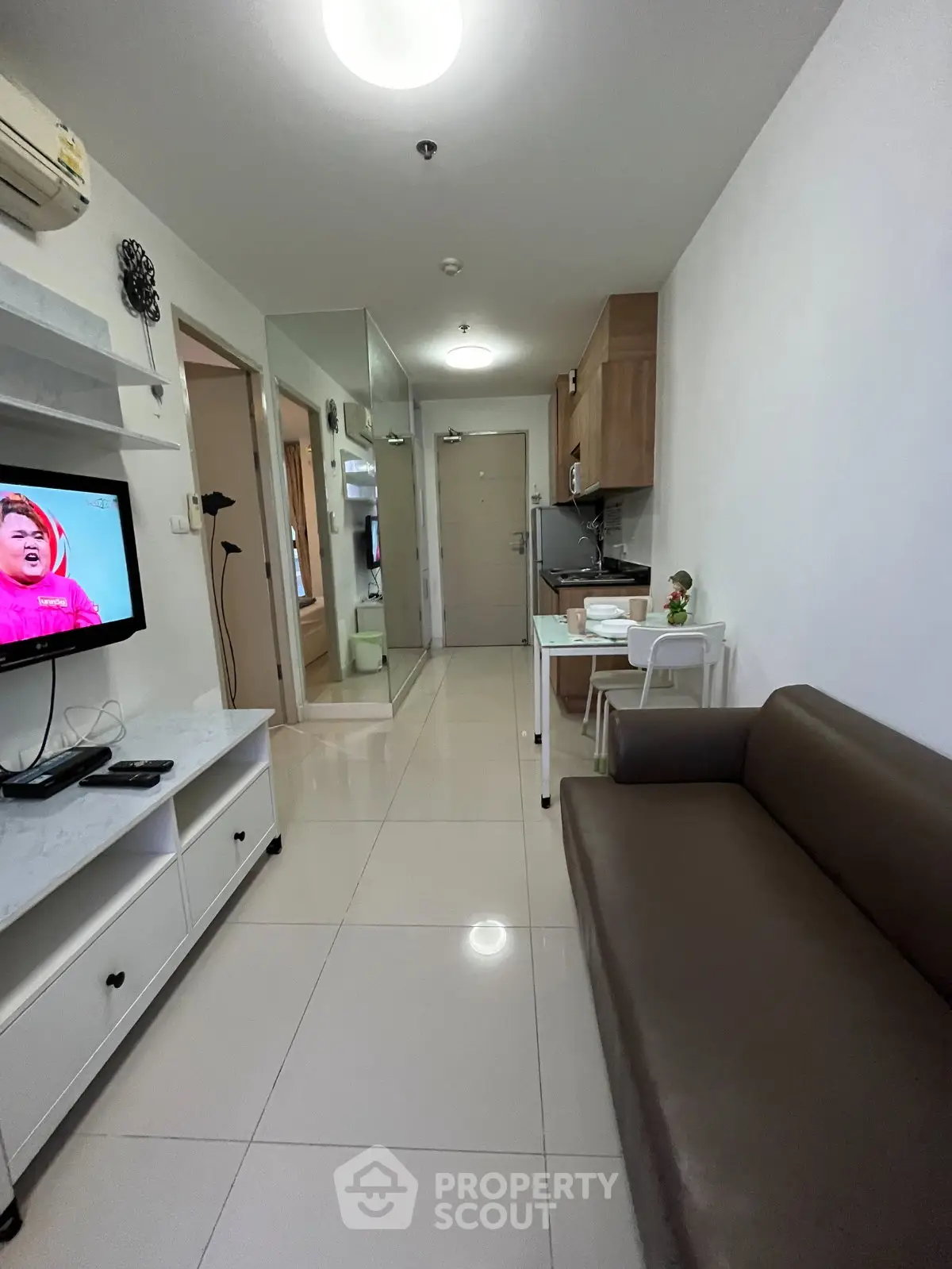 Modern apartment interior with sleek living room and compact kitchen layout.