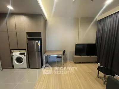 Modern living room with washing machine and sleek TV setup, perfect for urban living.