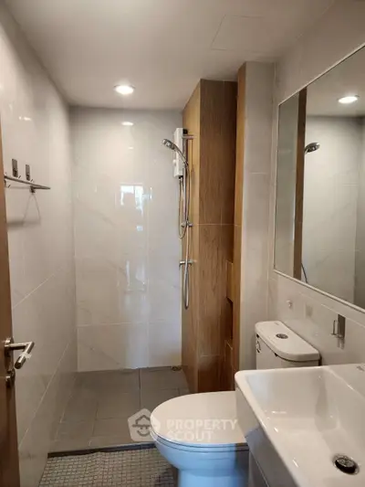 Modern bathroom with sleek fixtures and spacious shower area