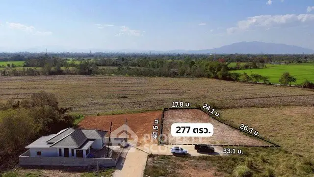 Scenic land plot with countryside views and a small house, ideal for development.