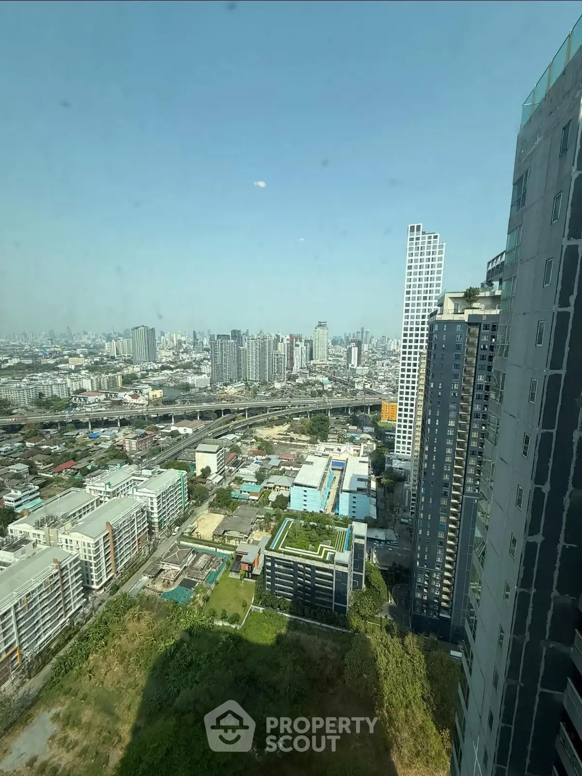 Stunning cityscape view from high-rise building showcasing urban skyline and modern architecture.