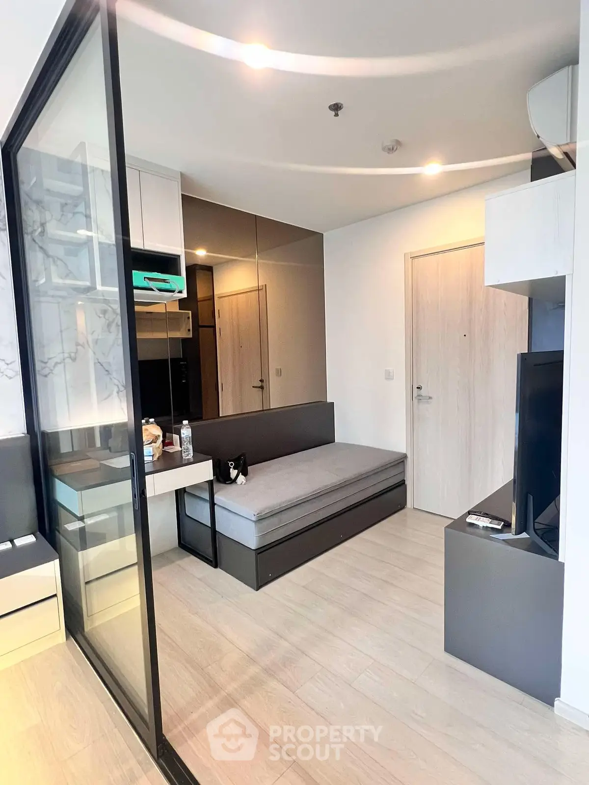 Modern compact living room with sleek design and glass partition