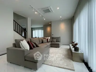 Spacious modern living room with plush sectional sofa and elegant decor