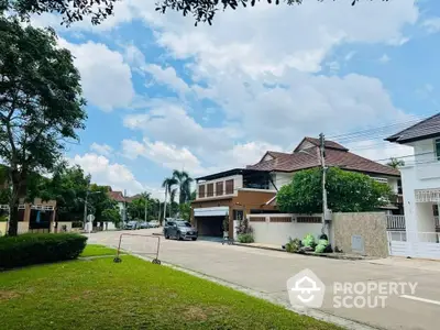 Serene suburban street showcasing elegant homes with manicured lawns under a clear blue sky, ideal for families seeking a peaceful neighborhood.