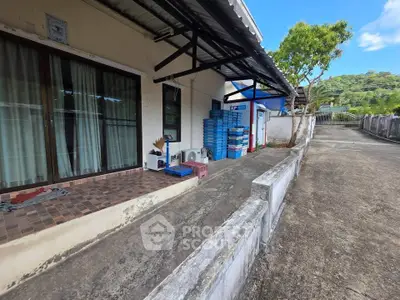 Charming exterior view of a property with a spacious patio and scenic surroundings, perfect for relaxation.