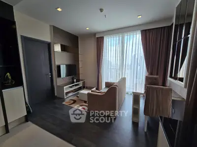 Modern living room with floor-to-ceiling windows and stylish furniture in a high-rise apartment.
