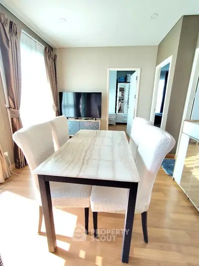 Bright dining area with elegant table and chairs, perfect for modern living.