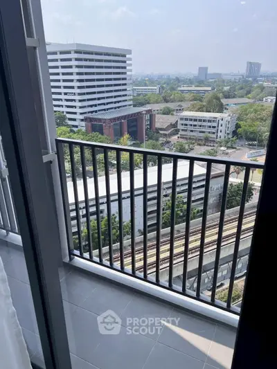 Stunning city view from a modern apartment balcony with sleek railing design.