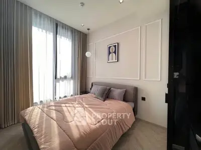 Modern bedroom with elegant decor and large window for natural light