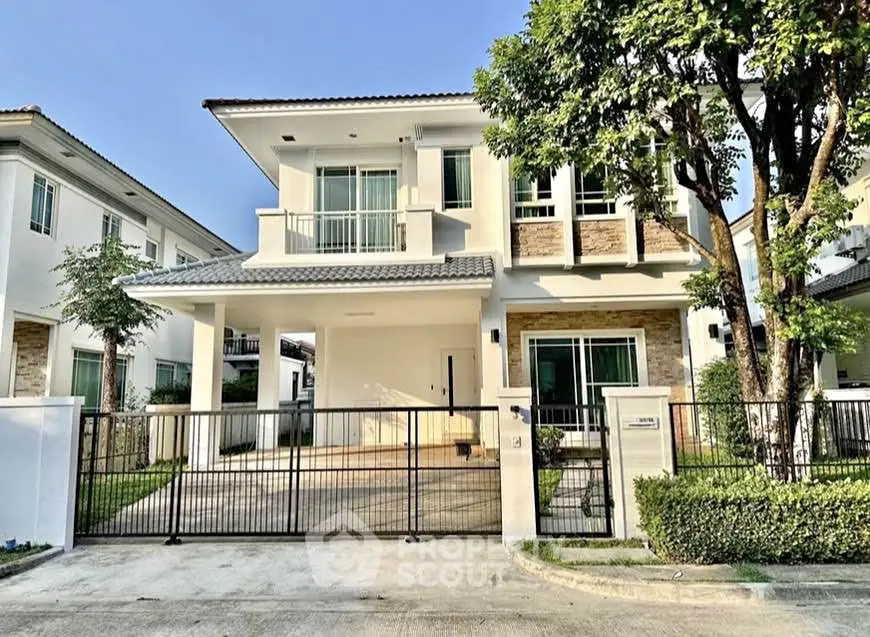 Elegant two-story house with modern design and spacious driveway in a serene neighborhood.