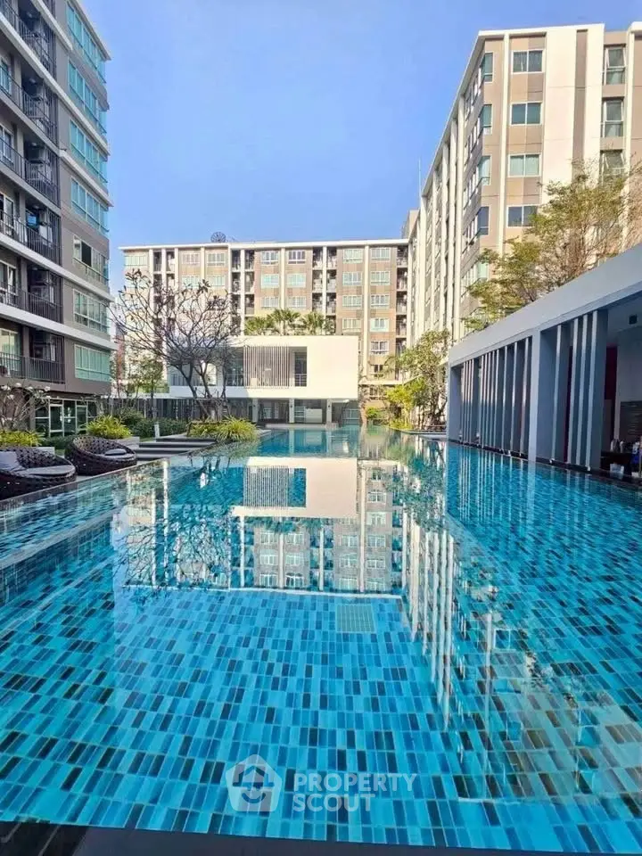 Luxurious apartment complex with stunning outdoor pool and modern architecture.