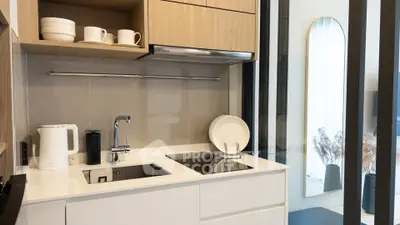 Modern kitchen with sleek design, featuring induction cooktop and stylish cabinetry.