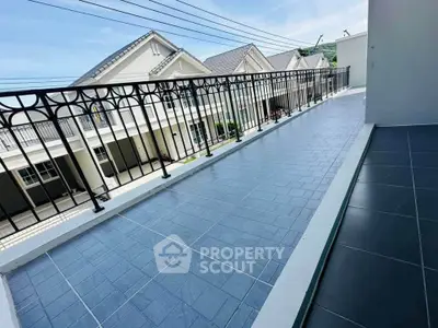 Spacious balcony with elegant railing and scenic neighborhood view