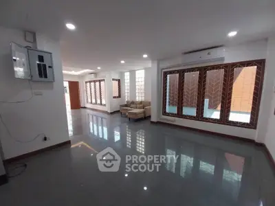 Spacious living room with modern design and large windows for natural light