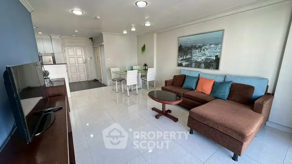 Spacious living room with modern decor and open kitchen layout