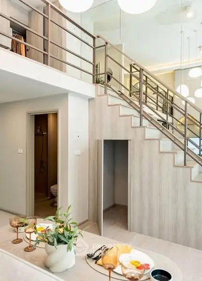 Modern duplex interior with stylish staircase and elegant dining setup