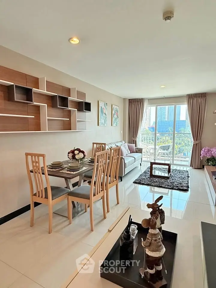 Modern living room with stylish decor and city view, featuring elegant dining area and cozy seating.