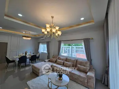 Luxurious living room with elegant chandelier and plush sectional sofa