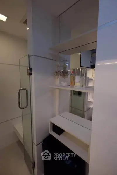 Modern bathroom with sleek glass shower and built-in shelving