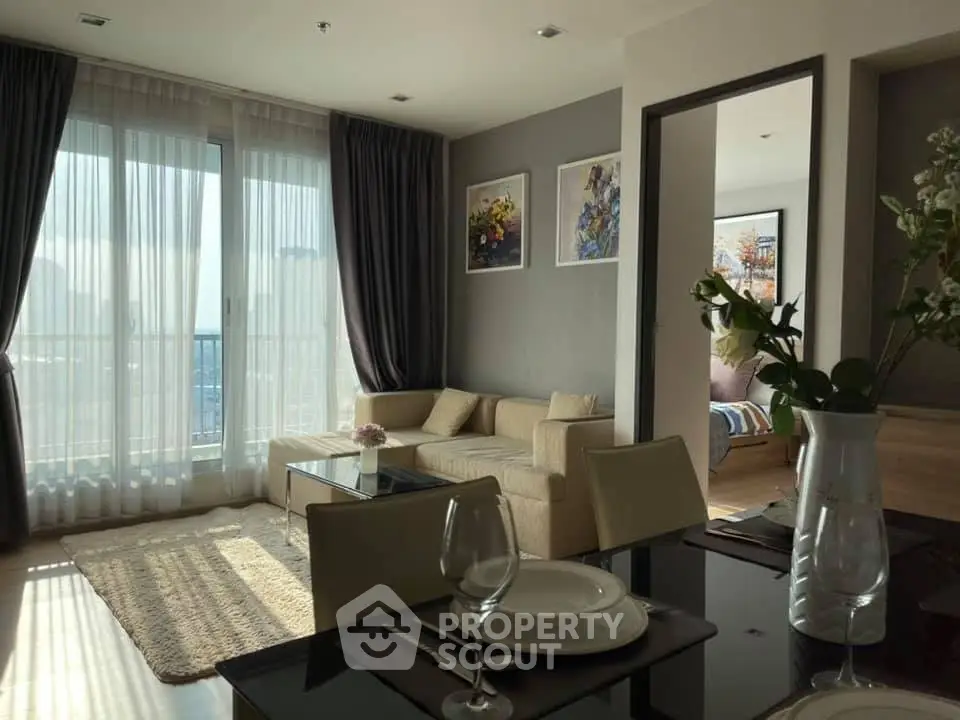 Elegant living room with large windows and stylish decor in modern apartment