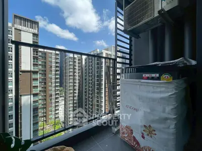 Modern balcony with city view and air conditioning unit in high-rise apartment.