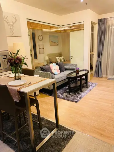 Stylish modern living room with cozy seating and elegant decor in a contemporary apartment.