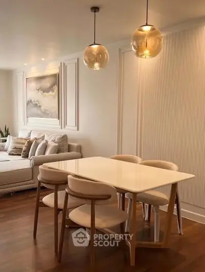 Elegant dining area with modern lighting and cozy seating in a stylish living room.