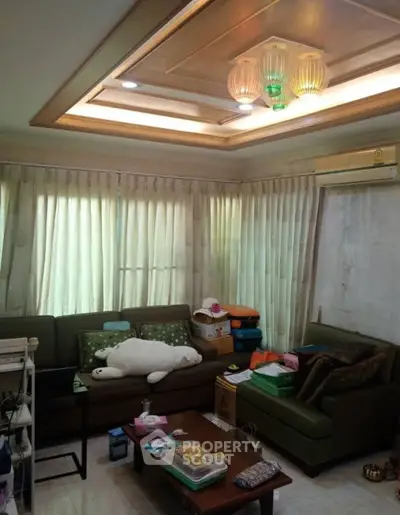 Cozy living room with natural light and comfortable seating, perfect for relaxation and gatherings.