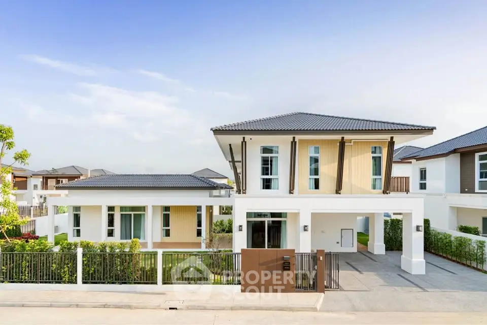 Stunning modern two-story house with spacious driveway and lush greenery in a serene neighborhood.
