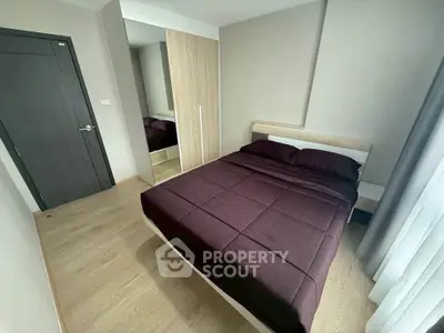 Modern bedroom with sleek design and cozy atmosphere, featuring a comfortable bed and stylish wardrobe.