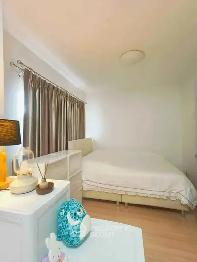 Cozy bedroom with elegant decor and ample natural light, featuring a comfortable bed and stylish furnishings.