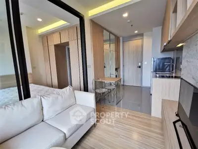 Modern studio apartment with cozy living area and sleek kitchen design